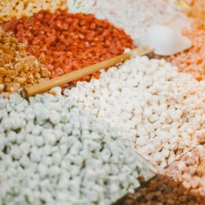 Colorful assortment of spices in a market with a focus on texture and variety.